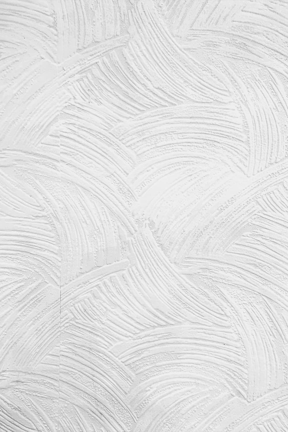 Detail of a white plastered wall with soft sweeping brush marks